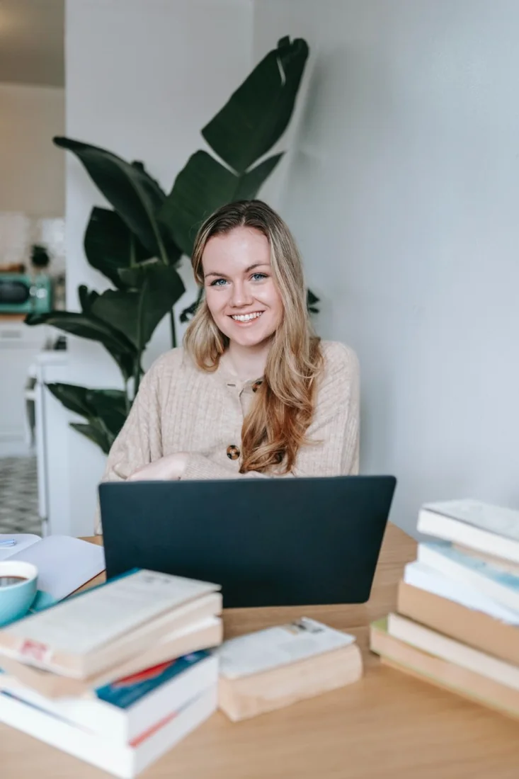 Happy woman smiling in front of a laptop